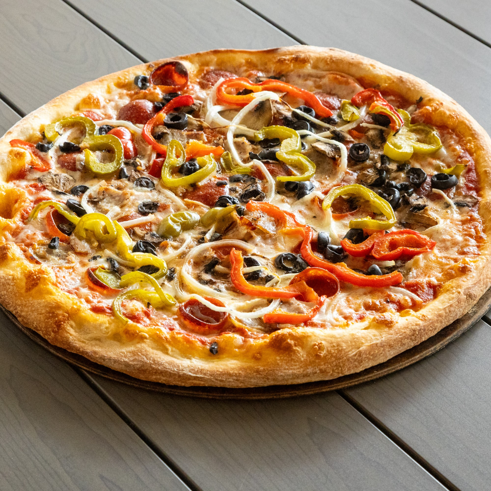 Annie's Pizza with pepperoni, mushrooms, olives, onions, and red and green bell peppers.