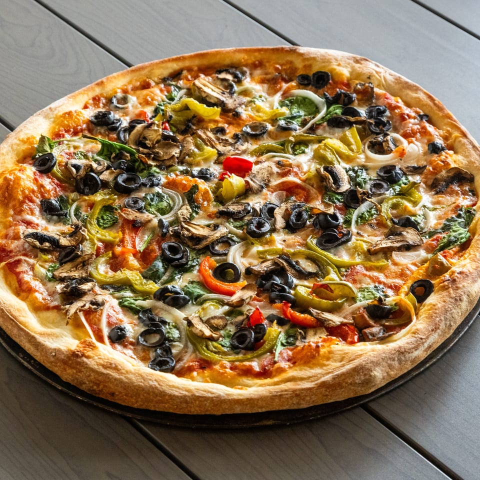 Annie's Pizza Subs & Wings' vegetarian pizza, topped with olives, mushrooms, peppers, and onions.